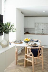 a kitchen with a table with a bowl of fruit on it at Richardson Apartment in Aberaeron