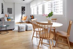 a living room with a table and chairs at Mundaiz by FeelFree Rentals in San Sebastián
