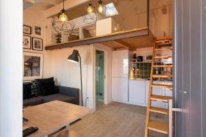 a small apartment with a loft bed and a desk at Mezzanine Stylish Apartments by Vacationy in Porto