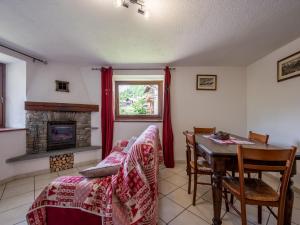 a living room with a table and a fireplace at Apartment Ville sur Sarre by Interhome in Sarre