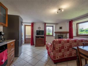 a living room with a couch and a television at Apartment Ville sur Sarre by Interhome in Sarre