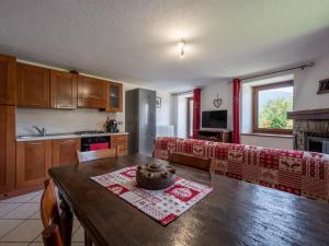 a kitchen and living room with a table and a couch at Apartment Ville sur Sarre by Interhome in Sarre