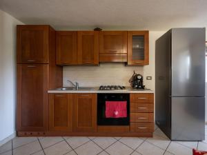 a kitchen with wooden cabinets and a stainless steel refrigerator at Apartment Ville sur Sarre by Interhome in Sarre +11 photos