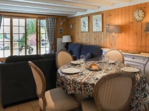 a dining room with a table and a couch at Apartment Argentière 3 by Interhome in Villars-sur-Ollon +18 photos