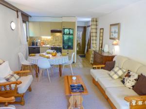 a living room with a couch and a table at Apartment Terrasse Des Alpes 3008 by Interhome in Vermala