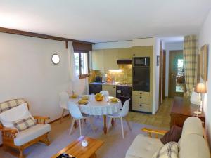 a kitchen and living room with a table and chairs at Apartment Terrasse Des Alpes 3008 by Interhome in Vermala +25 photos