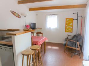 a kitchen and dining room with a table and chairs at Holiday Home Les Palombes-7 by Interhome in Lacanau-Océan