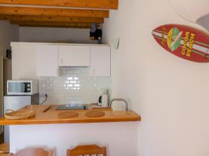 a kitchen with white cabinets and a counter top at Holiday Home Les Palombes-7 by Interhome in Lacanau-Océan