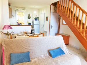 a living room with a couch and a staircase at Holiday Home Mer Indigo-3 by Interhome in Saint Pierre La Mer