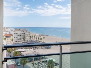 a balcony with a view of a beach and the ocean at Studio Casino-3 by Interhome in Canet-en-Roussillon