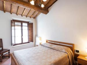 a bedroom with a bed and a window at Apartment Ciliegio by Interhome in Monsanto