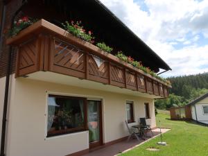 a house with a balcony with flowers on it at Apartment Hoch by Interhome in Neukirch