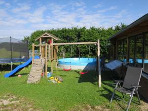 a playground with a slide and a swing at Apartment Dreser by Interhome in Kottenborn