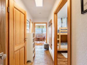 a hallway with a door leading to a dining room at Apartment Appartement Andrea by Interhome in Grünholzer +25 photos