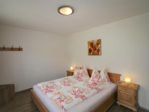 a bedroom with a bed with two candles on it at Apartment Christian by Interhome in Fügen +23 photos