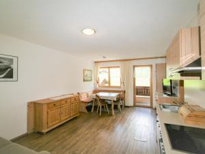 a kitchen with a table and a dining room at Apartment Christian by Interhome in Fügen