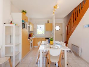 Hauteville-sur-MerにあるHoliday Home Oscar - HSM402 by Interhomeのキッチン、ダイニングルーム(テーブル、椅子付)