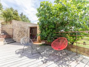 two chairs and a table on a deck at Holiday Home Chaud'abri - NYS170 by Interhome in Venterol