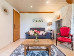 a living room with a blue couch and red chairs at Holiday Home Chaud'abri - NYS170 by Interhome in Venterol