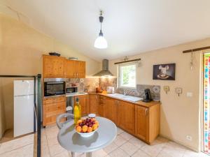 a kitchen with a table with a bowl of fruit on it at Holiday Home Chaud'abri - NYS170 by Interhome in Venterol