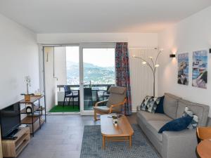 a living room with a couch and a table at Apartment Residenza Monte Bré - Apt-204 Haus2 by Interhome in Lugano