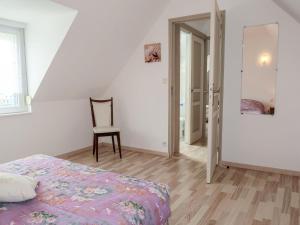 a bedroom with a bed and a chair in it at Holiday Home Le Sémaphore by Interhome in Pleubian +17 photos