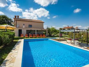 a villa with a swimming pool and a house at Holiday Home Villa Emanuela - IPC100 by Interhome in Pićan