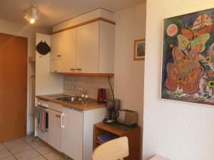 a small kitchen with a sink and a counter at Apartment Chalet Abendrot-11 by Interhome in Grindelwald