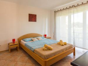 a bedroom with a bed with yellow towels on it at Apartment Giuliano-4 by Interhome in Frata