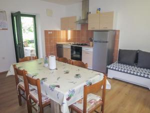 una cocina con una mesa y sillas y una cocina con una mesa y una mesa en Holiday Home Marija by Interhome, en Starigrad-Paklenica