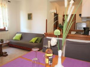 een woonkamer met een bank en een tafel bij Apartment Mirjana-1 by Interhome in Ružići