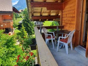a patio with a table and chairs on a house at Apartment Chalet Abendrot-19 by Interhome in Grindelwald