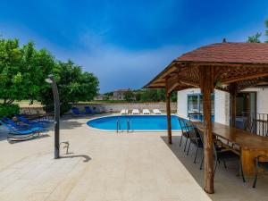 a patio with a pavilion and a swimming pool at Holiday Home Jadranka by Interhome in Muntić