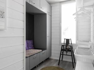 a room with a closet with a bench and a ladder at Holiday Home Villa biegga by Interhome in Kyrö +11 photos