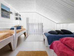 a bedroom with two beds and two rugs at Holiday Home Villa biegga by Interhome in Kyrö