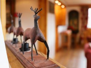 a bronze figurine of a group of deer on a table at Apartment Rhodonite 24 by Interhome in Villars-sur-Ollon