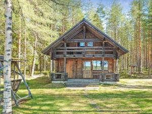 a log cabin in the middle of a forest at Holiday Home Haapala by Interhome in Soini