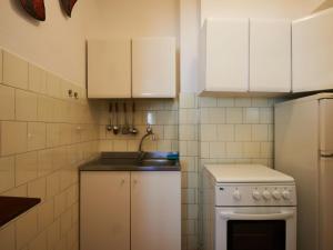 a small kitchen with white cabinets and a sink at Apartment Marta - GLA161 by Interhome in Gera Lario +26 photos