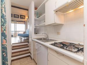 a kitchen with a stove and a sink at Apartment Spinnaker by Interhome in Palau +18 photos