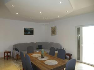 a dining room with a table and a couch at Holiday Home Tina by Interhome in Biograd na Moru +21 photos