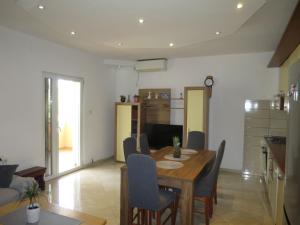 a kitchen and dining room with a wooden table and chairs at Holiday Home Tina by Interhome in Biograd na Moru
