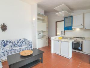 kuchnia i salon z kanapą i stołem w obiekcie Holiday Home Nicoletta by Interhome w mieście Palau