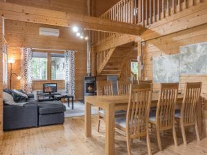 a dining room and living room with a table and chairs at Holiday Home Pursiranta by Interhome in Keränen