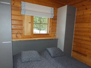 a small room with a bed and a window at Holiday Home Aaretti by Interhome in Arrakoski