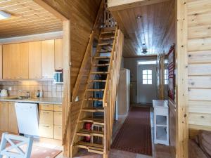 a staircase leading up to a kitchen in a tiny house at Holiday Home Ylläskankare by Interhome in Äkäslompolo +16 photos