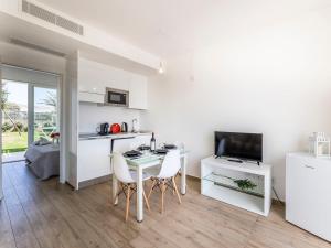 a kitchen and living room with a table and chairs at Apartment Capo Falcone Charming Apartment-2 by Interhome in Villa Sirena +43 photos