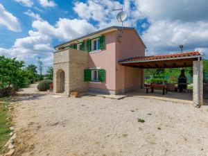 a small house with a patio in front of it at Holiday Home Villa Malini by Interhome in Boškari
