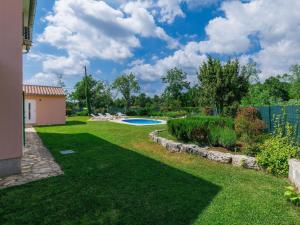 a yard with a swimming pool and a fence at Holiday Home Villa Malini by Interhome in Boškari