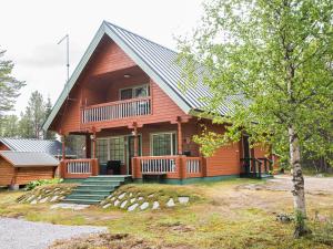 a log cabin with a porch and stairs leading to it at Holiday Home Lomamaja 1 by Interhome in Raattama