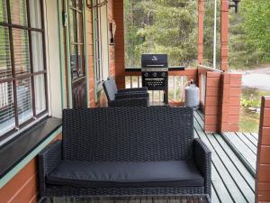 a porch with a bench on the front of a house at Holiday Home Lomamaja 1 by Interhome in Raattama
